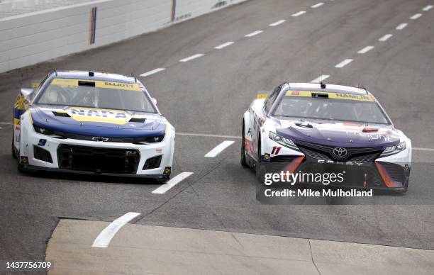 Chase Elliott, driver of the NAPA Auto Parts Chevrolet, and Denny Hamlin, driver of the FedEx Freight Direct Toyota, race during the NASCAR Cup...