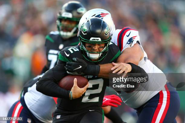 Zach Wilson of the New York Jets is sacked by Lawrence Guy of the New England Patriots during the fourth quarter at MetLife Stadium on October 30,...