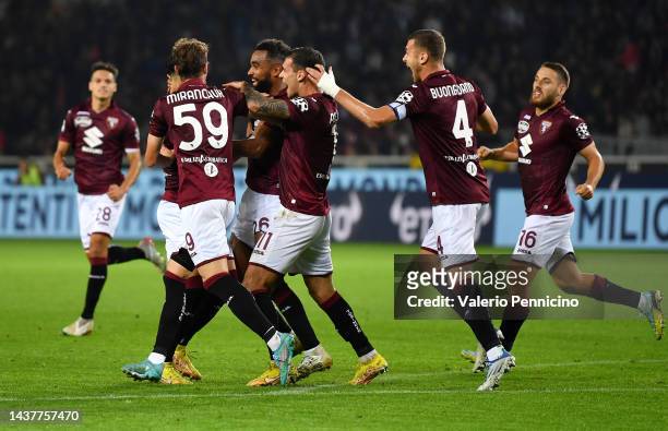 Koffi Djidji of Torino FC celebrates with teammates after scoring their team's first goal during the Serie A match between Torino FC and AC MIlan at...