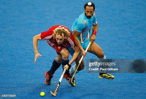 Richard Alexander of Great Britain battles for the ball with Sardar Singh of India during the Men's preliminary match between Great Britain and India...