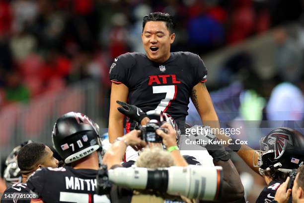 Younghoe Koo of the Atlanta Falcons is carried off the field after making the game-winning overtime field goal against the Carolina Panthers at...