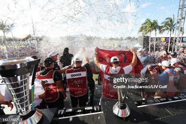 Team Captain Dustin Johnson, Patrick Reed, Pat Perez and Talor Gooch of 4 Aces GC celebrate their team win with their caddies on stage after the team...