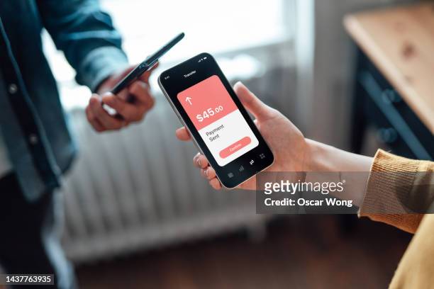 money transfer via mobile app on smartphone - sending payment stock pictures, royalty-free photos & images