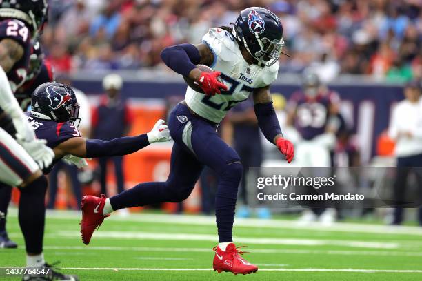 Derrick Henry of the Tennessee Titans rushes for a touchdown as Jonathan Owens of the Houston Texans defends during the second quarter at NRG Stadium...