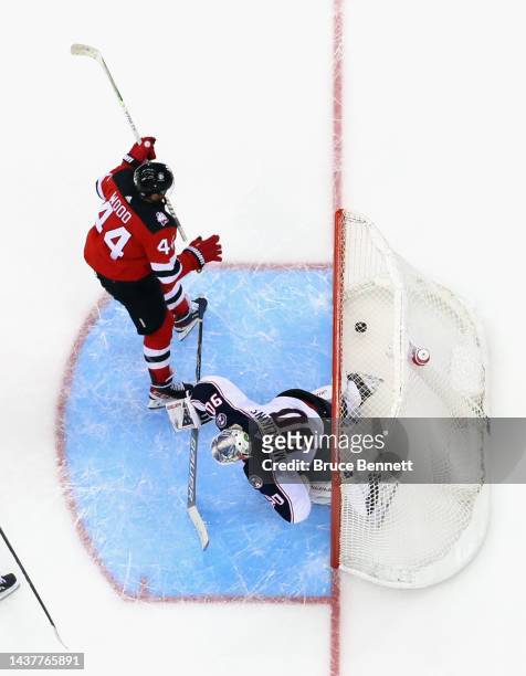 Miles Wood of the New Jersey Devils scores a third period goal against Elvis Merzlikins of the Columbus Blue Jackets at the Prudential Center on...