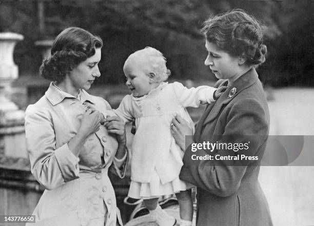 Queen Elizabeth II and her sister Princess Margaret and baby daughter Princess Anne in the grounds of Balmoral Castle in Scotland, 21st August 1951.