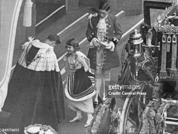 The future Queen Elizabeth II arrives at Westminster Abbey for the coronation of her father, King George VI, 12th May 1937. She is greeted by the...