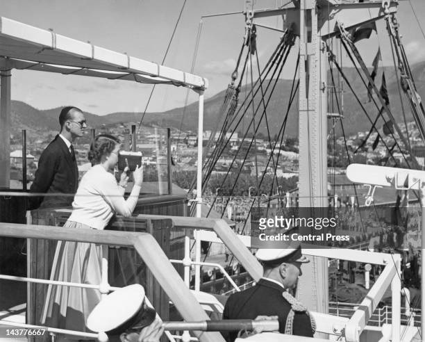 Queen Elizabeth II and Prince Philip on the bridge of the royal yacht 'SS Gothic' as it enters Hobart harbour in Tasmania, 20th February 1954.