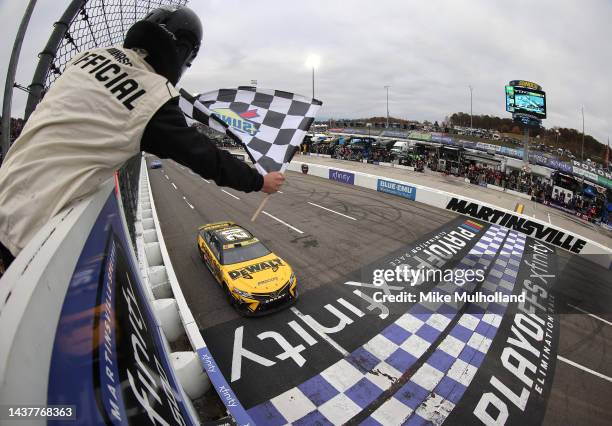 Christopher Bell, driver of the DeWalt Toyota, takes the checkered flag to win the NASCAR Cup Series Xfinity 500 at Martinsville Speedway on October...