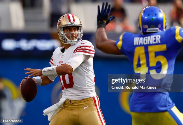 Jimmy Garoppolo of the San Francisco 49ers throws the ball as Bobby Wagner of the Los Angeles Rams defends during the second quarter at SoFi Stadium...