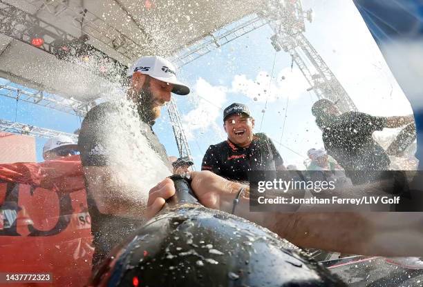 Team Captain Dustin Johnson, Patrick Reed and Pat Perez of 4 Aces GC celebrate their team win with champagne on stage after the team championship...