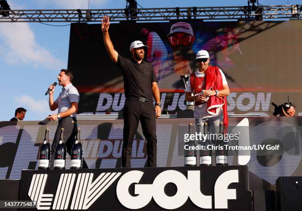 Champion Team Captain Dustin Johnson of 4 Aces GC and caddie Austin Johnson celebrate on stage during the team championship stroke-play round of the...