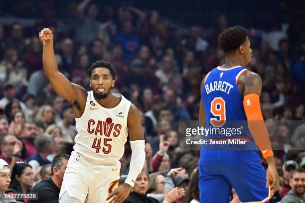 Donovan Mitchell of the Cleveland Cavaliers reacts after shooting over RJ Barrett of the New York Knicks during the first quarter of the game at...