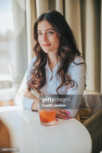 beautiful woman sitting in restaurant in business investment meeting and listening - bar drink establishment stock pictures, royalty-free photos & images