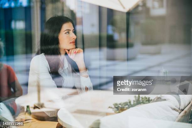 beautiful woman sitting in restaurant in business investment meeting - bar drink establishment stock pictures, royalty-free photos & images