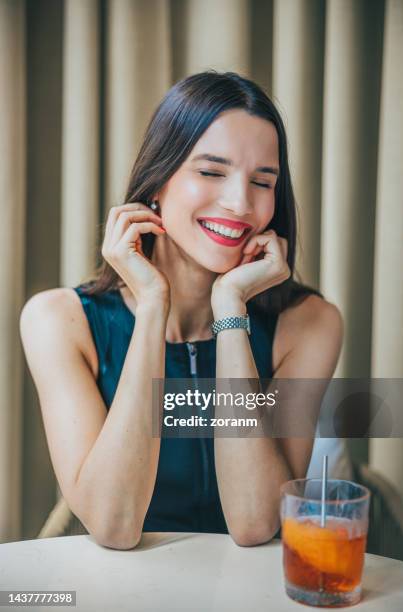 beautiful woman sitting in restaurant in business investment meeting and smiling with pleasure - bar drink establishment stock pictures, royalty-free photos & images