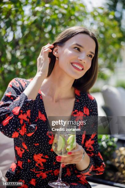 beautiful woman having cocktail in business investment meeting in outdoor lounge café - bar drink establishment stock pictures, royalty-free photos & images