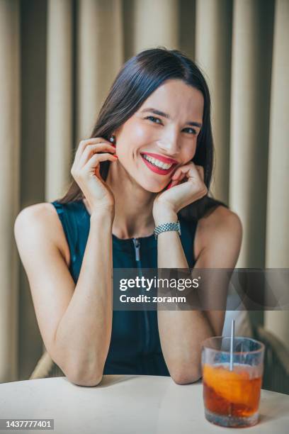 beautiful woman sitting in restaurant in business investment meeting and smiling gladly - bar drink establishment stock pictures, royalty-free photos & images