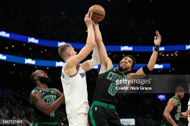 Jayson Tatum of the Boston Celtics fights Kristaps Porzingis of the Washington Wizards for the ball during the second quarter of the game at TD...