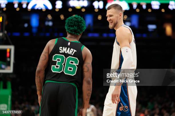 Kristaps Porzingis of the Washington Wizards reacts with Marcus Smart of the Boston Celtics during the first quarter of the game at TD Garden on...