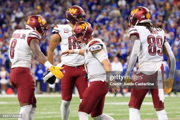 Taylor Heinicke of the Washington Commanders celebrates a touchdown in the fourth quarter of a game against the Indianapolis Colts at Lucas Oil...