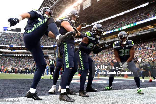 Members of the Seattle Seahawks celebrate a turnover during the fourth quarter against the New York Giants at Lumen Field on October 30, 2022 in...