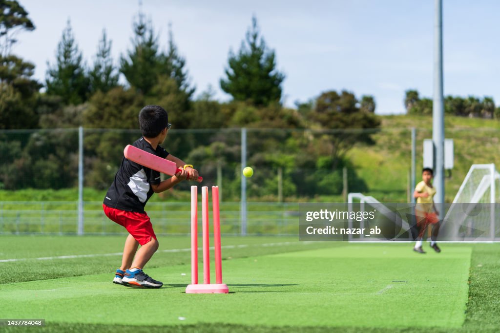 Kids loving the game of cricket.