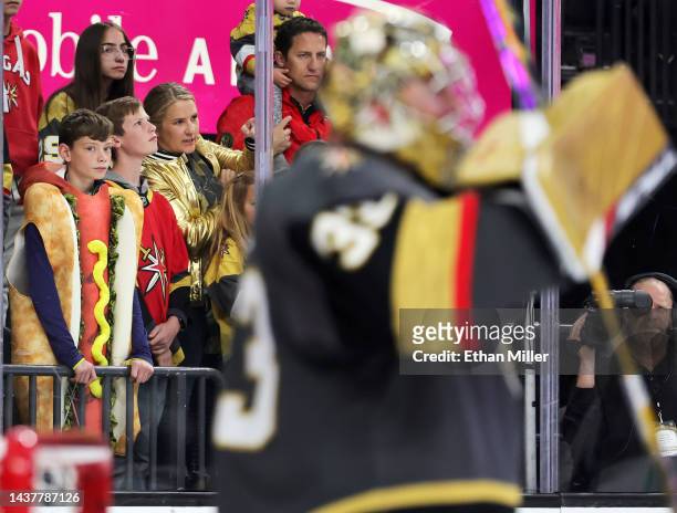 Fan dressed in a hot dog Halloween costume looks on as Adin Hill of the Vegas Golden Knights warms up before a game against the Winnipeg Jets at...