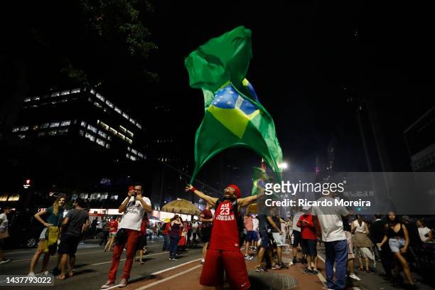 Supporter of newly elected president Luiz Inácio Lula da Silva celebrates after his victory on presidential runoff day on October 30, 2022 in Sao...