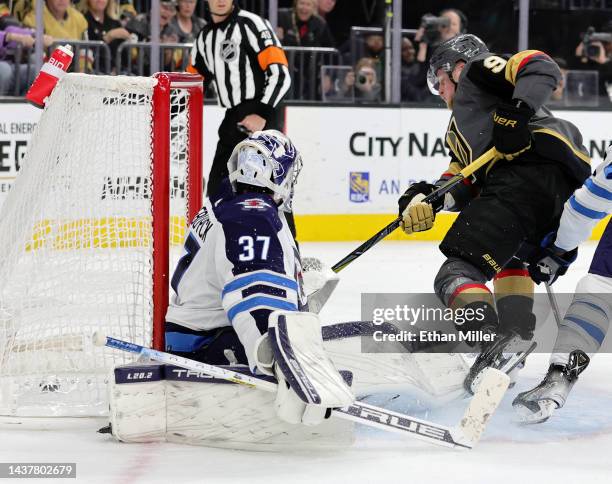 Jack Eichel of the Vegas Golden Knights scores a goal in overtime against Connor Hellebuyck of the Winnipeg Jets to win their game 2-1 at T-Mobile...