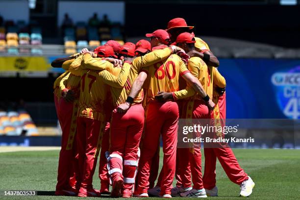 The Zimbabwe players embrace during the ICC Men's T20 World Cup match between Bangladesh and Zimbabwe at The Gabba on October 30, 2022 in Brisbane,...