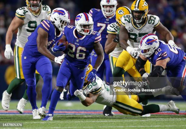 Devin Singletary of the Buffalo Bills is tackled by Isaiah McDuffie of the Green Bay Packers during the fourth quarter at Highmark Stadium on October...