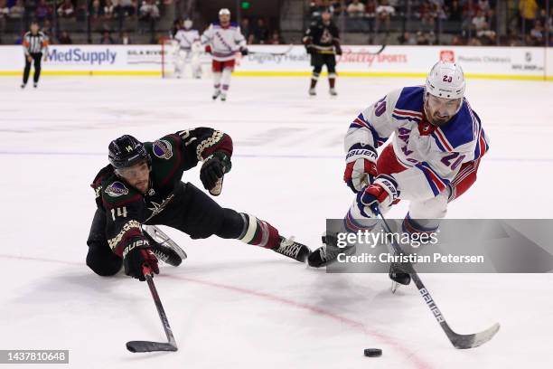 Chris Kreider of the New York Rangers attempts to control the puck against Shayne Gostisbehere of the Arizona Coyotes during the third period of the...