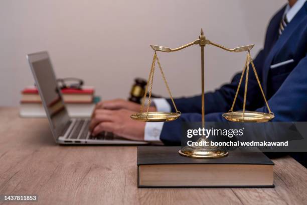 male lawyer working with contract papers and wooden gavel on tabel in courtroom. justice and law ,attorney, court judge, concept. - advogada imagens e fotografias de stock