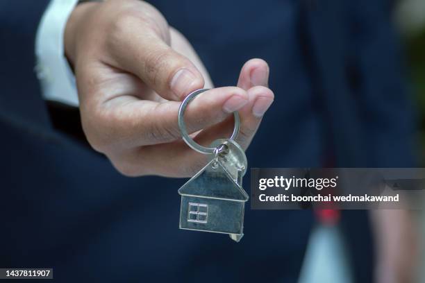 real estate agent handing over house keys - landlord stock pictures, royalty-free photos & images