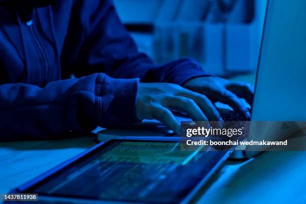 wanted hackers coding virus ransomware using laptops and computers. cyber attack, system breaking and malware concept. - data breach stock pictures, royalty-free photos & images