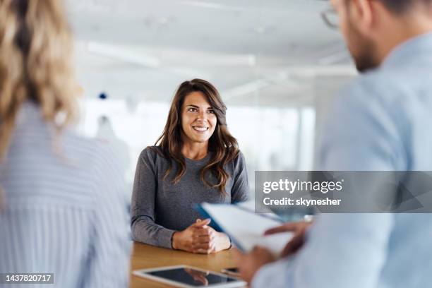 happy female candidate on a job interview in the office. - werk zoeken stockfoto's en -beelden