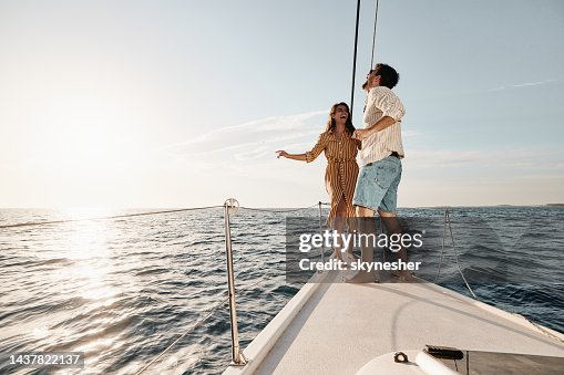 Young carefree couple dancing in summer day on a yacht. Young carefree couple dancing in summer day on a yacht.