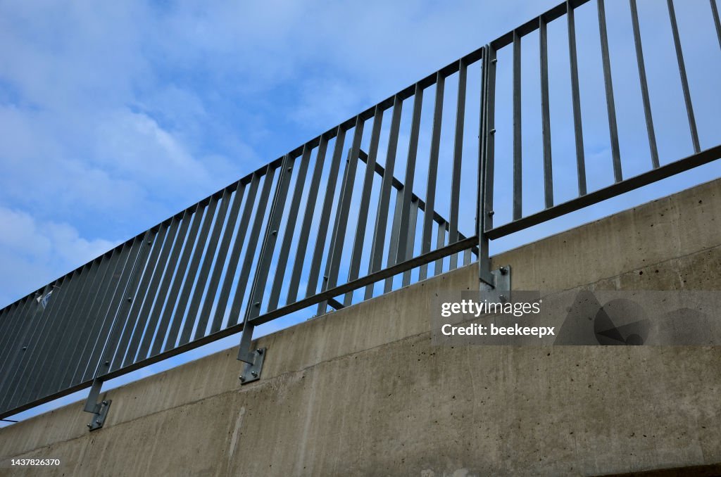 Bride Railing Post A Bridge Railing With Vertical Fence Posts Anchored Into The Ground ...