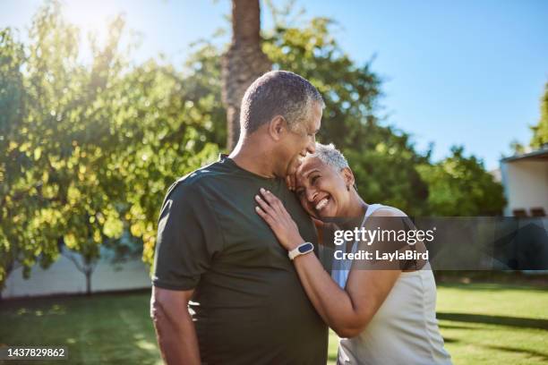 retirement, love and couple with a senior man and woman hugging, laughing and having fun together in the home garden. happy, smile and bonding with an elderly male and female pensioner in the yard - friends smile bildbanksfoton och bilder