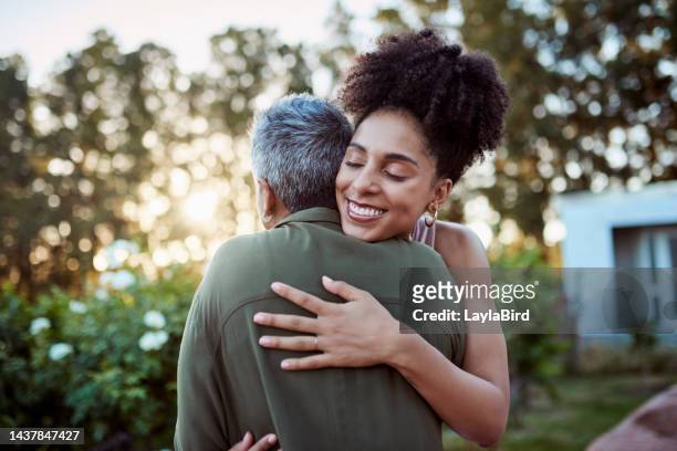 hug, mother and daughter with love and care together in a garden of a retirement home. happy, young and excited girl hugging her senior and elderly mom in a park or backyard of a house during a visit - young woman and senior lady in a park stock pictures, royalty-free photos & images