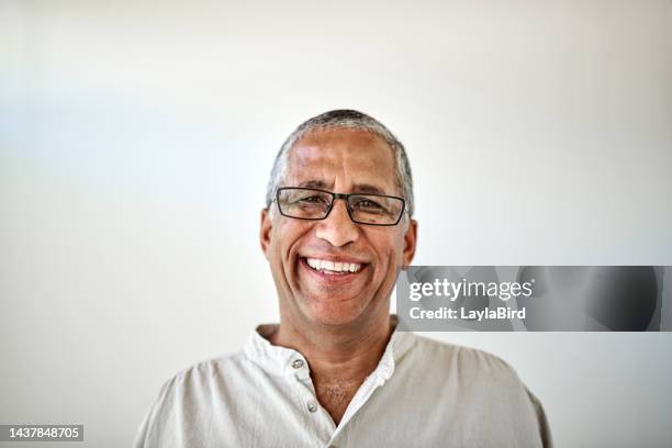 happy senior man, smile portrait with white wall background and relax sitting in home with glasses. elderly retirement, old happiness and confident black man with proud face, in house or nursing home - mid section bildbanksfoton och bilder