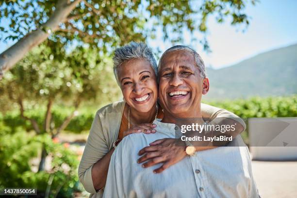 senior couple, smile and outdoor in nature park showing love, care and happy on a retirement holiday on summer day. portrait of elderly man and woman together for fresh air and tree view on vacation - active seniors bildbanksfoton och bilder