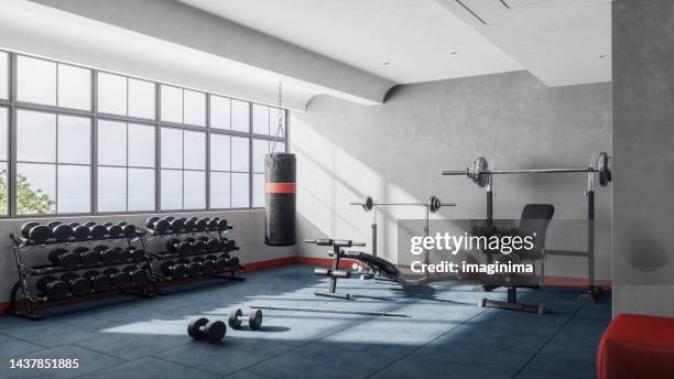 équipement de musculation dans un gymnase moderne - poids et haltères photos et images de collection