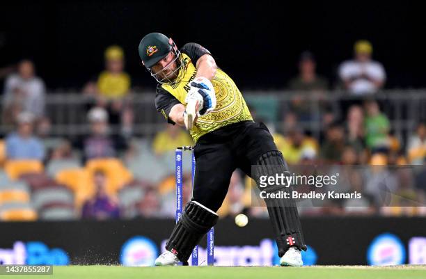Aaron Finch of Australia hits the ball to the boundary for a four during the ICC Men's T20 World Cup match between Australia and Ireland at The Gabba...