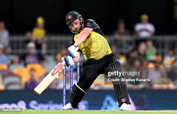 Aaron Finch of Australia hits the ball to the boundary for a four during the ICC Men's T20 World Cup match between Australia and Ireland at The Gabba...