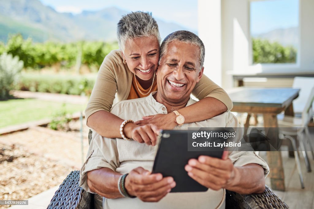 Outdoor, online and senior couple using a tablet for video call, internet and social media. Old man and woman with digital tech for chatting, call and texting on retirement home patio in Mexico