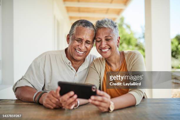 phone, video call and senior couple relax in backyard, bond and laughing at online conversation. happy family, mature man and woman talking on phone call while sitting on patio, retirement lifestyle - senior couple funny imagens e fotografias de stock