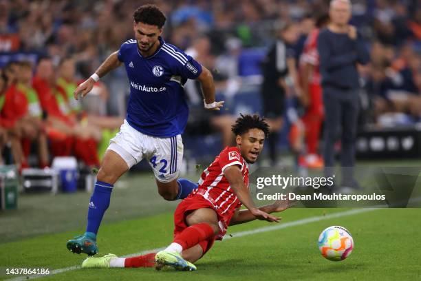 Kevin Schade of SC Freiburg battles for the ball with Kerim Calhanoglu of Schalke during the Bundesliga match between FC Schalke 04 and Sport-Club...