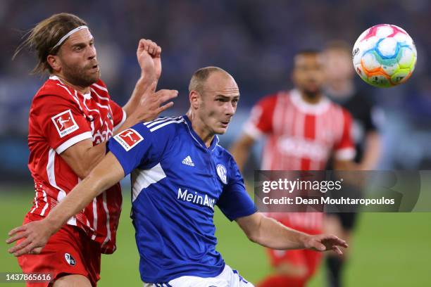 Lucas Holer of SC Freiburg battles for the ball with Henning Matriciani of Schalke during the Bundesliga match between FC Schalke 04 and Sport-Club...